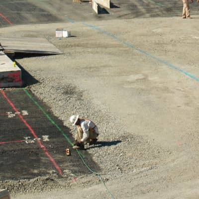 Construction site layout markings - ALTA SURVEY Fortworth Worker marking layout lines on a construction site during construction staking