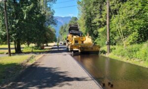 Road construction crew paving a rural road during active site work